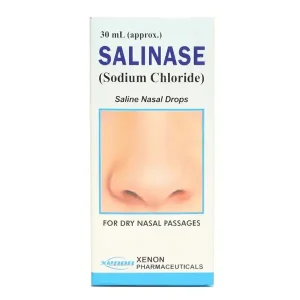 Bottle of Salinase N-Spray surrounded by nasal drops and saline solution.