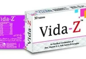 A bottle of Vida-Z tablets with scattered tablets and nutritional ingredients in the background.