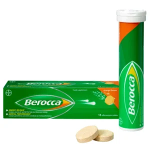 A glass of water with a dissolving Berocca tablet and a bottle of Berocca tablets.