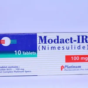 A blister pack of Modact-IR 100mg tablets with one tablet visible, placed on a blue surface.