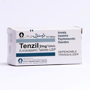 A blister pack of Tenzil tablets with a white pill visible, resting on a blue surface.